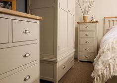 a bedroom scene with focus on the dresser and bed