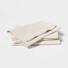 three folded linen napkins sitting on top of each other