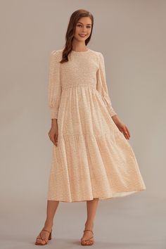 Floral Long Sleeve Round Neck Smocked Tiered Midi Dress.Designed with a shirred bodice, long puff sleeves, and pockets this dress is going to be the Fall showstopper. She��s fully lined, fully iconic, + fully flirty. Pair with your favorite sneakers or ankle boots and accessorize with a wide brim hat or jewelry! Feminine Long Sleeve Midi Dress With Smocked Cuffs, Summer Long Sleeve Midi Dress With Smock, Feminine Midi-length Smocked Dress, Cream Midi-length Smocked Dress, Modest Midi-length Smocked Dress With Floral Print, Modesty Outfits, Tiered Midi Dress, Long Puff Sleeves, Wide Brimmed Hats