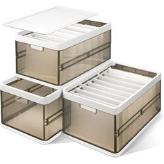 three plastic storage boxes stacked on top of each other, with lids and drawers open