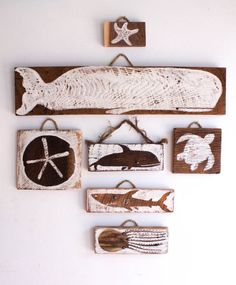 wooden wall hangings with fish and starfish on them