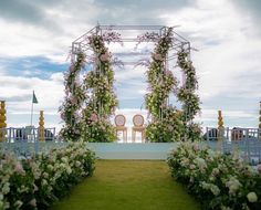 an outdoor ceremony set up with flowers and greenery