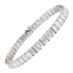 Stunning modern straight emerald cut diamond tennis bracelet. High jewelry by Alexander Beverly Hills. 50 emerald cut diamonds, 17.15 carats (apx 0.34ct each). Approximately G color and VS clarity. 18k white gold, 19.85 grams. Accommodated with an up to date appraisal by a GIA G.G., please contact us with any questions. Thank you. Item Number B3762 Luxury Rectangular Diamond Cut Tennis Bracelet, Formal Emerald Cut Diamond Bracelet With Single Cut Diamonds, Classic Emerald Cut Baguette Diamond Tennis Bracelet, Silver Emerald Cut Tennis Bracelet, Luxury Emerald Cut Diamond Tennis Bracelet, Luxury Emerald Cut Tennis Bracelet With 17 Jewels, Luxury White Gold Emerald Cut Diamond Bracelet, Emerald Cut Baguette Diamond Bracelets, Classic Emerald Cut Diamond Bracelet With Baguette Diamonds