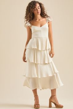 Bronwyn Maxi Dress in Ivory | Altar'd State Feminine Cream Maxi Dress With Ruffles, Flowy Tiered Maxi Dress, Chic Flowy Tiered Skirt Maxi Dress, Tiered Ruffle Dress With Layered Hem, Chic Cream Midi Dress With Ruffles, Elegant Dress With Ruffled Skirt And Flutter Sleeves, Elegant Ruffled Skirt Dress With Flutter Sleeves, Elegant Tiered Ruffle Maxi Dress, Elegant Ruffle Dress For Garden Party With Tiered Skirt