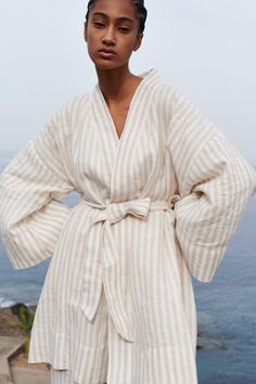 "Wrap yourself in comfort and style with our short striped linen robe with pockets. Crafted from luxurious 100% linen from a medium weight fabric, this robe is perfect for lounging at home or adding a touch of elegance to your morning routine. The timeless striped design adds a chic flair, while the convenient pockets provide functionality and convenience. Whether you're sipping your morning coffee or unwinding after a long day, this robe is sure to become your go-to favorite. Treat yourself to luxury and relaxation with our short striped linen robe with pockets ️.  READY FOR GIFT!  ✨ Gift message available (please write the message in the comments field).   All packages are packed in our original eco-friendly white boxes made from recycled paper. DETAILS: - Pure 100% linen fabric - OEKO-T Striped Long Sleeve Robe For Loungewear, White Spring Kimono For Relaxation, Chic White Kimono For Loungewear, White Summer Kimono For Relaxation, Summer White Kimono For Relaxation, Relaxed Fit Linen Robe For Spring, Relaxed Fit Beige Kimono For Loungewear, Beige Relaxed Fit Kimono For Loungewear, Linen Robe For Daywear