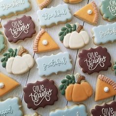 decorated cookies are arranged on a table with words and pumpkins in the middle one is for give thanks