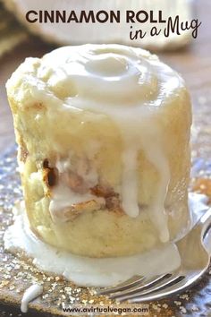 cinnamon roll in a muffin on a plate with a fork