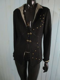 Vintage wool jacket. Black with two unusual clasps and scattered metal studs across the front.  Good condition. Dimensions: Bust: 38 Inches. Length: 23 Inches. Sleeve: 18 Inches. Made in France Fitted Winter Outerwear With Studs, Winter Fitted Studded Outerwear, Fitted Studded Winter Outerwear, Studded Winter Outerwear, Studded Long Sleeve Winter Outerwear, Gothic Winter Outerwear With Studs, Gothic Studded Winter Outerwear, Gothic Studded Outerwear For Winter, Vintage Jackets Retro