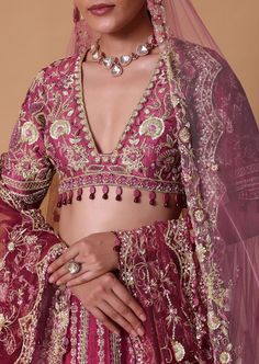 Embark on a journey of timeless elegance with our lotus motif bridal lehenga set. Crafted from a luxurious blend of red and light pink raw silk this ensemble exudes regal charm and sophistication perfect for the modern bride. Adorned with intricate lotus motifs it is completed with a stunning dori tassel back blouse. Paired with an embellished dupatta and a complementing trail dupatta this ensemble will ensure that your wedding day is nothing short of magical. Dry clean only if required. Slight variation in color is possible due to digital photography. Elegant Sharara With Meenakari For Reception, Elegant Pink Kundan Sets, Elegant Pink Kundan Jewelry Sets, Elegant Meenakari Lehenga In Traditional Drape, Elegant Meenakari Lehenga With Traditional Drape, Elegant Pink Lehenga With Pallu, Elegant Festive Sharara With Meenakari Details, Elegant Pink Cutdana Lehenga, Elegant Festive Sharara With Meenakari