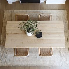 an overhead view of a table with chairs and a potted plant on the top