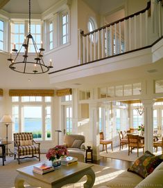 a living room filled with furniture and lots of windows