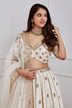 White lehenga with gold dori, aari and sequin embroidery. Comes with blouse and organza dupatta.
Component: 3
Pattern: Embroidery
Type Of Work: Sequin, Dori and Aari
Neckline: V neck
Sleeve Type: Half
Fabric: Chanderi and Organza; Lining: Shantoon
Color: White
Other Details: 
Dupatta with embroidered cutwork border
Blouse with curved hem
Cutwork detail waistband
Note: Only selling the product mentioned in the description from the video.
Occasion: Wedding - Aza Fashions Traditional Gold Palazzo Set With Zari Work, Elegant Choli With Gota Work For Diwali, Elegant Gota Work Choli For Diwali, Elegant Kundan Palazzo Set For Wedding, Elegant Navratri Choli With Gota Work, Elegant Gota Work Choli For Navratri, Reception Meenakari Dola Silk Choli, Meenakari Choli For Reception And Festivals, Elegant Palazzo Set For Wedding