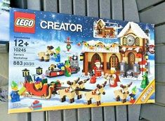 the lego creator christmas village set is in its original box, complete with santa's sleigh and reindeers