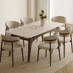 a dining room table with six chairs around it