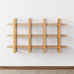 an empty room with a wooden shelf on the wall