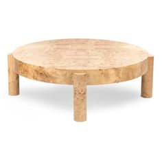 a round wooden table sitting on top of a white floor