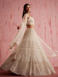 Experience the captivating charm of amayra ivory lehenga, exquisitely inspired by the floral embroidery . Embellished with a mesmerising sequenced hand done floral motifs , this lehenga showcases the pinnacle of artistry. The same floral inspired dupatta and elegant strappy blouse further enhance the ensemble's beauty, creating a harmonious and distinctive look. White Semi-stitched Hand Embellished Lehenga, White Hand Embellished Semi-stitched Lehenga, White Semi-stitched Hand Embellished Choli, Cream Hand Embellished Lehenga For Reception, Hand Embellished Cream Lehenga For Reception, White Hand Embellished Lehenga For Festive Occasions, Off White Georgette Lehenga With Intricate Embroidery, Wedding Lehenga In Off White With Mirror Work, Cream Lehenga With Mirror Work In Georgette