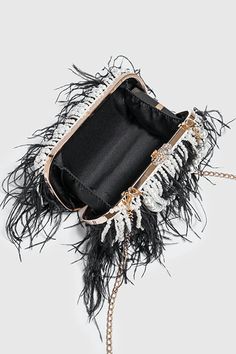 Elevate your style with our Pearl Fringe Feather Handbag. This luxurious accessory seamlessly blends the classic charm of pearls, the playful elegance of fringe detailing, and the exotic allure of feathers. The handbag is a true embodiment of sophistication, perfect for making a statement at upscale events and adding a touch of glamour to your ensemble. Carry it with confidence and let your unique sense of style shine. Luxury Formal Bags With Feathers, Elegant Evening Bags With Feathers, Luxury Formal Feathered Bags, Chic Formal Bags With Feathers, Chic Fringe Clutch For Parties, Formal Chic Bags With Feathers, Chic Formal Feather Bags, Chic Formal Feathered Bags, Elegant Black Bag With Tassels