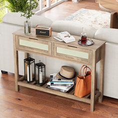 a living room with a couch, coffee table and books on the shelf next to it