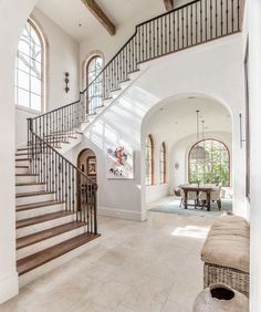 a living room filled with furniture and a staircase