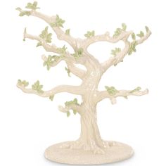 a figurine of a tree with green leaves on the branches and white base