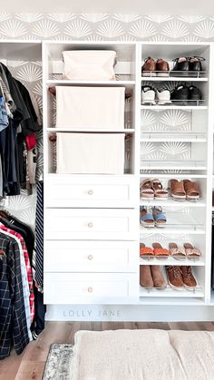 an organized closet with clothes and shoes on shelves in white painted wood paneled closet doors