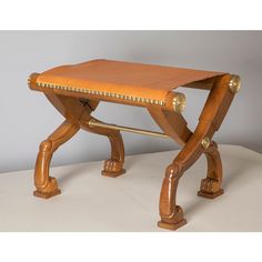 a small wooden bench sitting on top of a white table