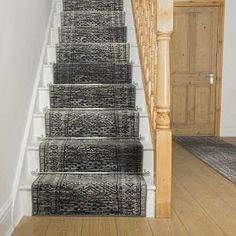 a staircase with carpeted steps leading up to the door