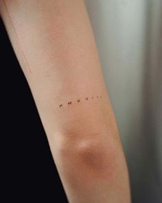 a woman's arm with the word love written on it and stars in the middle