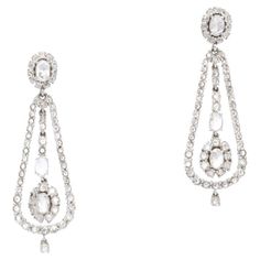 These feminine and pleasingly graceful earrings are beautifully handmade in 18k white gold. The details are as follows : Diamond weight : 2 carats + 0.74 carats ( HI color and SI clarity ) Metal: 18K white gold Measurements : length : 1 2/3 inches Total weight ; 8.07 grams Elegant White Gold Pear-shaped Chandelier Earrings, Exquisite White Diamond Earrings For Evening, Diamond White Hand Set Chandelier Earrings For Formal Occasions, Diamond White Platinum Bridal Earrings For Evening, Formal Rose Cut Diamond Chandelier Earrings, Platinum Bridal Earrings With Diamond Accents For Evening, Exquisite White Platinum Earrings, Elegant Chandelier Earrings With Rose Cut Diamonds, Formal Chandelier Earrings With Rose Cut Diamonds