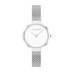 Enhance your everyday look with the understated elegance of this ladies' Calvin Klein silver-toned watch with a mesh bracelet and white dial. The minimalist white sunray dial features silver-toned hands. 28.0mm stainless steel case with mineral crystal Japanese quartz movement keeps accurate time. The stainless steel mesh bracelet secures with a sliding buckle clasp. Water resistant to 30 meters, this watch includes a 2-year limited manufacturer warranty. We are an authorized Calvin Klein dealer Calvin Klein Watch, Mens Highlights, Ck Calvin Klein, Mesh Bracelet, Stainless Steel Mesh, Women Wrist Watch, White Dial, Minerals Crystals, Silver Watch