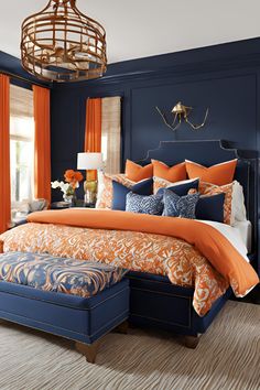 a bedroom with orange and blue decor on the walls, along with a large bed