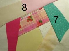 the number eight is placed on top of several different pieces of quilting material that have been folded together