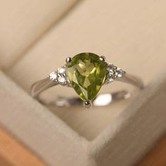 This ring features a 7*9 mm pear cut natural peridot. Customization is available. It is made by hand, and it will take about 7 days to finish the ring after your payment is completed. Main stone: 7*9 mm pear cut natuarl peridot Main stone weight: 1.71 ct Metal type: sterling silver /14k gold Accent stone: cz Customization is available, just fee free to contact me, it is free to engrave inside the ring, it is free, you can leave a ntoe with your order, but it will be great no more than 15 letter. Sterling Silver Pear-shaped Ring For Anniversary, Sterling Silver Pear Shaped Ring For Anniversary, Pear Shaped Sterling Silver Anniversary Rings, Pear-shaped Sterling Silver Anniversary Ring, White Gold Sterling Silver Pear-shaped Ring, Pear-shaped White Gold Sterling Silver Ring, Pear Shaped White Gold Sterling Silver Rings, Sterling Silver Solitaire Pear Rings, Pear-shaped Birthstone Promise Ring