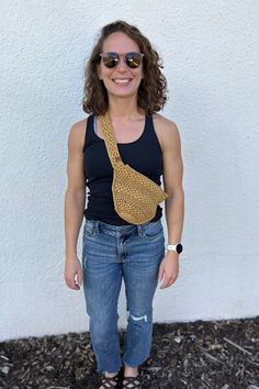 These belt bags are such a fun accessory to hold your belongings. They were handmade using a washable tape yarn in a beautiful yellow, maroon, or turquoise color.  There is a flap that folds over and is placed against your body while wearing to make it nice and secure. The opening on the bag is limited to 7 inches so that it is even more safe but still easy to access anything inside. Size of Belt Bag: 11 inches by 7 inches Strap: 29 inches Total length around: 40 inches Machine wash, lay flat to dry. Just be sure to remove leather LoopinCrafts tag when washing. Pattern: https://www.lakesideloops.com/ulla/ Crochet Belt Bag, Crochet Belt, Belt Bags, Turquoise Color, 11 Inches, Belt Bag, Minneapolis, Cross Body Handbags, Lay Flat