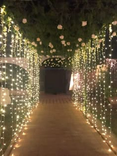 the walkway is covered with lights and flowers