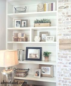 a living room filled with lots of white shelves