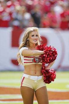 a cheerleader is performing on the field