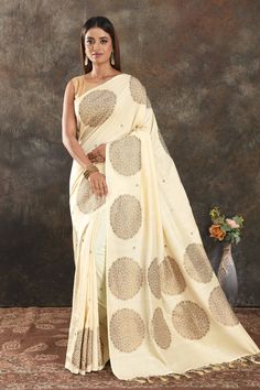 Buy beautiful cream Muga Banarasi saree online in USA with antique zari motifs. Be vision of elegance on special occasions in exquisite designer sarees, handwoven sarees, georgette sarees, embroidered sarees, Banarasi saree, pure silk saris from Pure Elegance Indian saree store in USA.-full view Traditional Drape Art Silk Blouse Piece In Cream, Designer Cream Pre-draped Saree For Diwali, Festive Cream Pre-draped Saree With Cutdana, Cream Raw Silk Saree Blouse Piece, Cream Raw Silk Blouse Piece For Saree, Bollywood Style Cream Raw Silk Saree, Festive Off White Raw Silk Traditional Wear, Festive Semi-stitched Cream Pre-draped Saree, Festive Off-white Raw Silk Traditional Wear