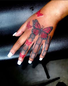 a woman's hand with a butterfly on it and hearts painted on the fingers