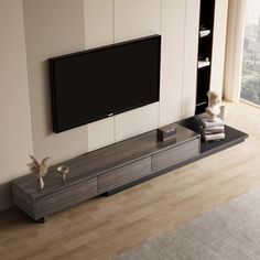 a large flat screen tv mounted to the side of a wall in a living room