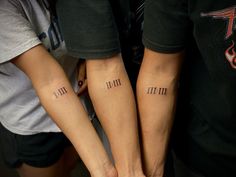 two people with matching tattoos on their arms, both showing the same time and date