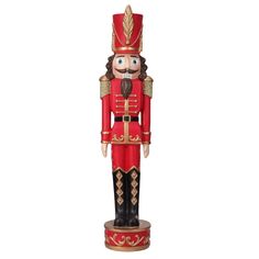 a red and black nutcracker statue on a white background