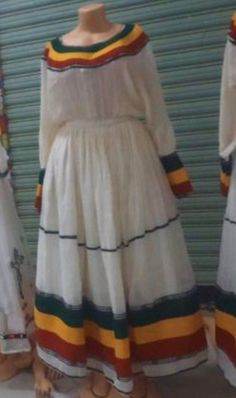 bahilwe kemis we have this Beautiful Ethiopian dress, 100% cotton and handmade. made in Ethiopia!  We also custom size orders as well!  #Kemis White Dresses With Weaving Work For Traditional Ceremonies, White Folk Dress With Weaving Work, Cotton Dresses For Traditional Ceremonies, Ceremonial White Handloom Dress, Fitted Cotton Dresses With Traditional Patterns, Fitted Cotton Dress For Traditional Ceremonies, Folk Style Cotton Dress With Traditional Patterns, Traditional Multicolor Cotton Dress, Traditional Off White Cotton Dress