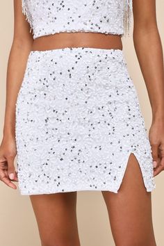 The party is here! The Lulus Glam of the Moment White Beaded Sequin Mini Skirt will outshine everyone with its shiny white and silver beads and sequins that dazzle across a mesh overlay (atop a white knit lining) that forms a high waist, an A-line silhouette, and a notched, mini hem. Hidden back zipper/clasp. Pair with the matching top for a complete look! Fit: This garment fits true to size. Length: Mid-thigh. Size medium measures 15.5" from waist to hem. Waist: Fitted - very fitted at natural Sequin Fabric With Rhinestones For Party, Summer Silver Sequined Mini Skirt, Elegant Sequined Mini Skirt For Summer, Glamorous Sequined Prom Skirt, Glamorous Sequined Skirt For Prom, Sequin Skirt For Wedding And Party Season, Wedding Skirt With Sequins For Party Season, Elegant Summer Bottoms With Contrast Sequin, Rhinestone Embellished Mini Skirt For Party