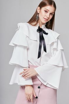 Bianca Tiered-Sleeve Blouse | Buttonless blouse with pleated edge collars, ruffled sleeves, and collar ribbon | Layered, pleated edge collar | Ruffled tiered sleeves | Collar ribbon | Machine wash cold Tiered Sleeve, Dress Neck Designs, Gorgeous Blouses, Kpop Style, Layered Blouse, Fashion Tops Blouse, Ruffle Sleeve Blouse, Frill Sleeves, Bow Blouse