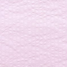 a pink background with small white dots on the top and bottom part of the fabric