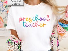 How cute is this colorful teacher tee?! This adorable Comfort Colors shirt comes in all the fun colors! Size up for oversized fit. Refer to size chart for measurement specifics. SIZING: *Unisex sizing *See size chart image for measurements DESCRIPTION: *SWEATSHIRTS: Unisex heavy blend crewneck sweatshirt Loose fit Runs true to size 50/50 cotton/polyester Sewn-in label No side seems *BELLA + CANVAS TEES: Unisex short sleeve tee 100% Airlume combed and ringspun cotton (fiber content may vary for different colors) Light fabric Tear away label Runs true to size *COMFORT COLORS TEES: Unisex short sleeve tee Medium fabric Relaxed fit Sewn-in twill label 100% ring-spun cotton No side seems *KIDS GILDAN TEES Unisex heavy cotton tee Tear away label  Shoulders have twill tape for improved durability White Relaxed Fit T-shirt, Colorful Playful Short Sleeve T-shirt, Casual Text Print T-shirt For Daycare, Playful Multicolor Shirt For School, Multicolor School Spirit T-shirt With Text Print, Multicolor Pre-shrunk Tops For School Spirit, Multicolor Text Print T-shirt For School Spirit, Trendy Multicolor School Shirt, Fun Multicolor Tops For School