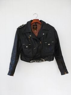 Vintage Black Leather Jacket For Fall, Vintage Biker Jacket For Biker Events, Fitted Vintage Outerwear With Belt Loops, Vintage Black Leather Jacket With Long Sleeves, Vintage Black Long Sleeve Leather Jacket, Vintage Fitted Biker Jacket For Biker Events, Vintage Black Biker Outerwear, Vintage Black Biker Jacket, Vintage Long Sleeve Biker Jacket