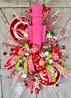 a wreath with pink candle and candy canes